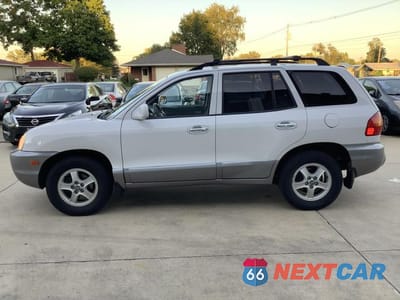 Czwarte zdjęcie samochodu z boku: 2002 HYUNDAI SANTA FE GLS VIN:KM8SC73D12U150049 - miniatura