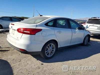 Trzecie zdjęcie samochodu z tyłu: 2017 FORD FOCUS SE VIN:1FADP3F20HL285659 - miniatura