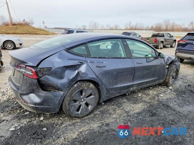 Trzecie zdjęcie samochodu z tyłu: 2023 TESLA MODEL 3 VIN:5YJ3E1EA3PF509260 - miniatura