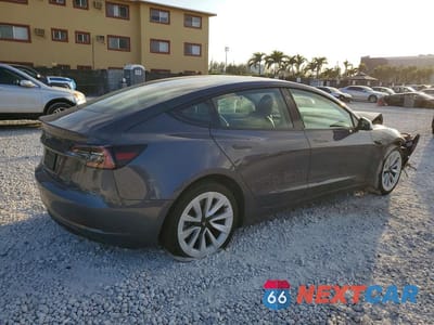 Trzecie zdjęcie samochodu z tyłu: 2023 TESLA MODEL 3 VIN:5YJ3E1EA0PF563230 - miniatura