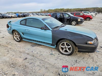 Czwarte zdjęcie samochodu z boku: 1997 FORD MUSTANG VIN:1FALP4040VF207937 - miniatura