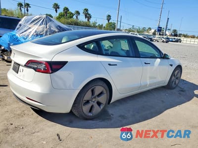 Trzecie zdjęcie samochodu z tyłu: 2023 TESLA MODEL 3 VIN:5YJ3E1EA9PF398200 - miniatura