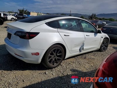 Trzecie zdjęcie samochodu z tyłu: 2023 TESLA MODEL 3 VIN:5YJ3E1EA7PF465358 - miniatura