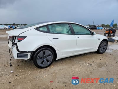 Trzecie zdjęcie samochodu z tyłu: 2023 TESLA MODEL 3 VIN:5YJ3E1EA8PF573813 - miniatura