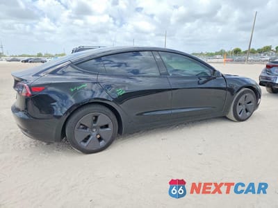 Trzecie zdjęcie samochodu z tyłu: 2023 TESLA MODEL 3 VIN:5YJ3E1EA6PF555844 - miniatura