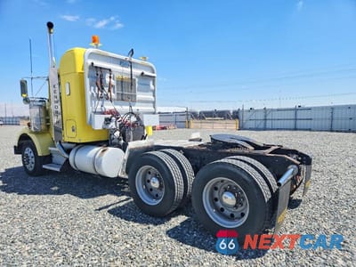 Trzecie zdjęcie samochodu z tyłu: 1999 KENWORTH CONSTRUCTI - SEMI TRUCK VIN:1XKDD69X2XR817022 - miniatura
