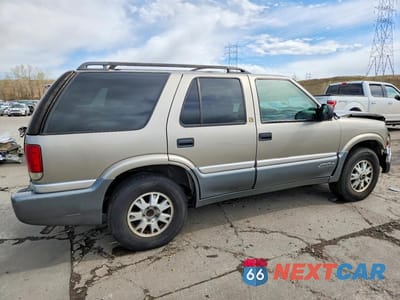 Trzecie zdjęcie samochodu z tyłu: 1999 GMC JIMMY VIN:1GKDT13WXX2549416 - miniatura