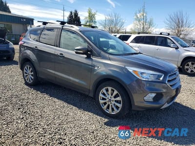 Czwarte zdjęcie samochodu z boku: 2017 FORD ESCAPE TITANIUM VIN:1FMCU9JD7HUD77500 - miniatura