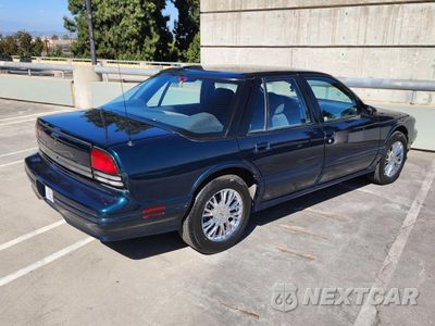 Czwarte zdjęcie samochodu z boku: 1995 OLDSMOBILE CUTLASS SUPREME SL VIN:1G3WH52M6SD334609 - miniatura