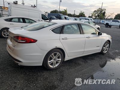 Trzecie zdjęcie samochodu z tyłu: 2018 FORD FUSION SE HYBRID VIN:3FA6P0LU6JR163523 - miniatura
