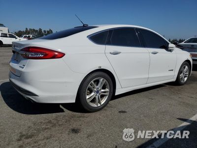 Trzecie zdjęcie samochodu z tyłu: 2018 FORD FUSION SE HYBRID VIN:3FA6P0LU7JR172120 - miniatura