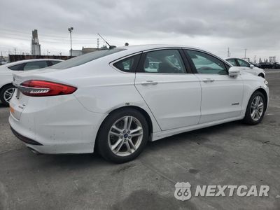 Trzecie zdjęcie samochodu z tyłu: 2018 FORD FUSION SE HYBRID VIN:3FA6P0LU7JR171713 - miniatura