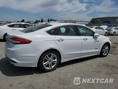 Trzecie zdjęcie samochodu z tyłu: 2018 FORD FUSION SE HYBRID VIN:3FA6P0LU1JR171528 - miniatura
