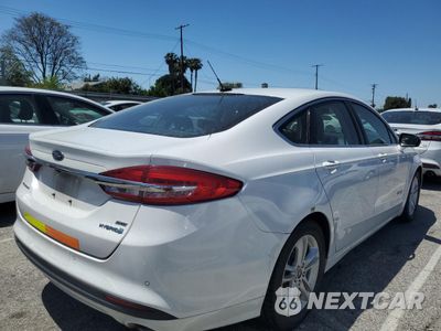 Trzecie zdjęcie samochodu z tyłu: 2018 FORD FUSION SE HYBRID VIN:3FA6P0LUXJR171530 - miniatura