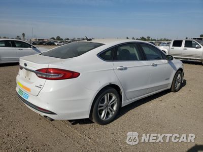 Trzecie zdjęcie samochodu z tyłu: 2018 FORD FUSION SE HYBRID VIN:3FA6P0LU6JR281877 - miniatura