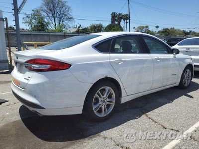 Trzecie zdjęcie samochodu z tyłu: 2018 FORD FUSION SE HYBRID VIN:3FA6P0LU1JR129957 - miniatura