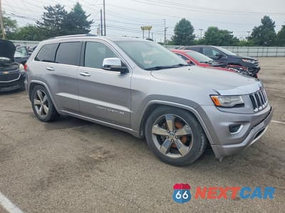 Czwarte zdjęcie samochodu z boku: 2014 JEEP GRAND CHEROKEE OVERLAND VIN:1C4RJFCG7EC523022 - miniatura