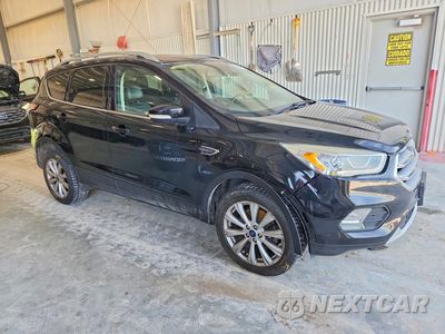 Czwarte zdjęcie samochodu z boku: 2017 FORD ESCAPE TITANIUM VIN:1FMCU9JD4HUD02401 - miniatura