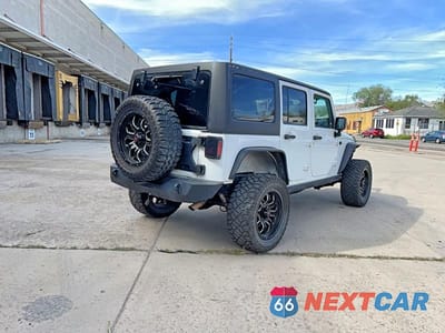 Czwarte zdjęcie samochodu z boku: 2013 JEEP WRANGLER UNLIMITED SPORT VIN:1C4HJWDG8DL601204 - miniatura