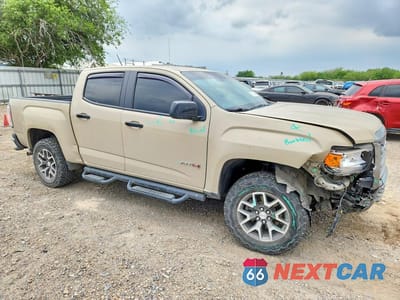 Czwarte zdjęcie samochodu z boku: 2021 GMC CANYON AT4 VIN:1GTG6FEN3M1206059 - miniatura