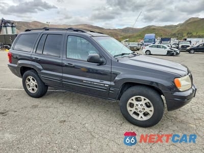 Czwarte zdjęcie samochodu z boku: 1999 JEEP GRAND CHEROKEE LIMITED VIN:1J4G268S3XC537241 - miniatura