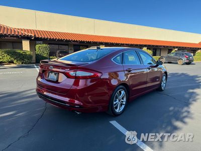 Czwarte zdjęcie samochodu z boku: 2016 FORD FUSION TITANIUM PHEV VIN:3FA6P0SUXGR320707 - miniatura