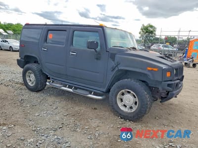 Czwarte zdjęcie samochodu z boku: 2003 HUMMER H2 VIN:5GRGN23U53H138681 - miniatura