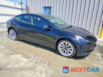 Czwarte zdjęcie samochodu z boku: 2022 TESLA MODEL 3 VIN:5YJ3E1EAXNF188623 - miniatura