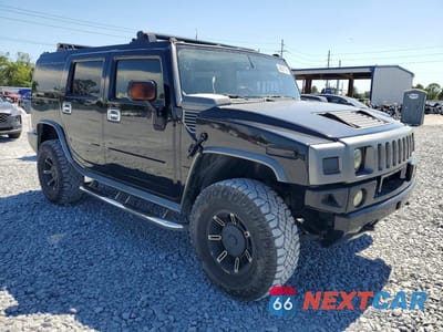 Czwarte zdjęcie samochodu z boku: 2003 HUMMER H2 VIN:5GRGN23U03H120685 - miniatura
