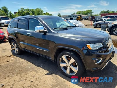 Czwarte zdjęcie samochodu z boku: 2014 JEEP GRAND CHEROKEE OVERLAND VIN:1C4RJECGXEC410191 - miniatura