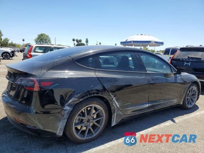 Trzecie zdjęcie samochodu z tyłu: 2023 TESLA MODEL 3 VIN:5YJ3E1EA4PF432625 - miniatura
