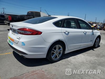 Trzecie zdjęcie samochodu z tyłu: 2018 FORD FUSION SE HYBRID VIN:3FA6P0LU1JR129960 - miniatura