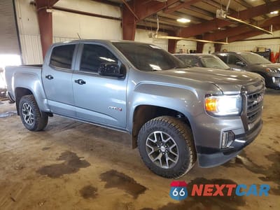 Czwarte zdjęcie samochodu z boku: 2021 GMC CANYON AT4 VIN:1GTG6FEN4M1106665 - miniatura