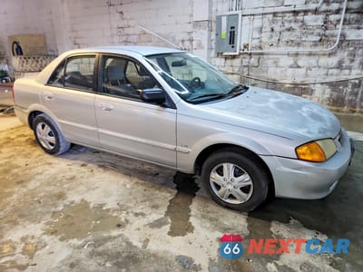 Czwarte zdjęcie samochodu z boku: 1999 MAZDA PROTEGE LX VIN:JM1BJ2220X0134923 - miniatura