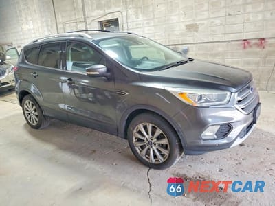 Czwarte zdjęcie samochodu z boku: 2017 FORD ESCAPE TITANIUM VIN:1FMCU9J97HUB33454 - miniatura