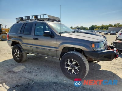 Czwarte zdjęcie samochodu z boku: 1999 JEEP GRAND CHEROKEE LAREDO VIN:1J4GW58S5XC687799 - miniatura