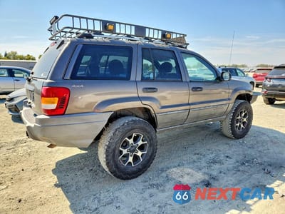Trzecie zdjęcie samochodu z tyłu: 1999 JEEP GRAND CHEROKEE LAREDO VIN:1J4GW58S5XC687799 - miniatura