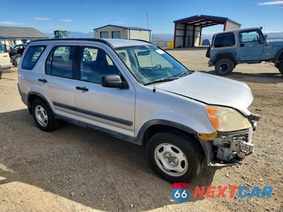 Czwarte zdjęcie samochodu z boku: 2002 HONDA CR-V LX VIN:JHLRD684X2C002459 - miniatura
