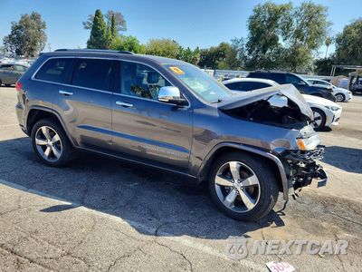 Czwarte zdjęcie samochodu z boku: 2014 JEEP GRAND CHEROKEE OVERLAND VIN:1C4RJECM1EC581448 - miniatura