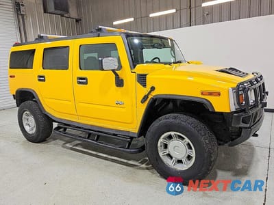 Czwarte zdjęcie samochodu z boku: 2003 HUMMER H2 VIN:5GRGN23U13H146938 - miniatura