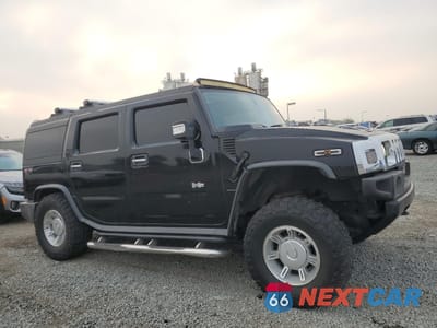 Czwarte zdjęcie samochodu z boku: 2003 HUMMER H2 VIN:5GRGN23U03H137888 - miniatura
