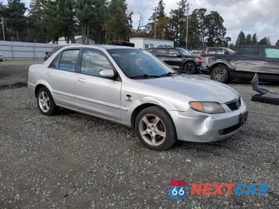 Czwarte zdjęcie samochodu z boku: 2003 MAZDA PROTEGE DX VIN:JM1BJ225530104806 - miniatura