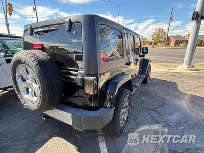 Czwarte zdjęcie samochodu z boku: 2014 JEEP WRANGLER UNLIMITED SAHARA VIN:1C4BJWEG2EL178982 - miniatura