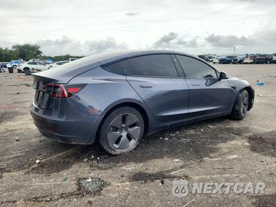 Trzecie zdjęcie samochodu z tyłu: 2023 TESLA MODEL 3 VIN:5YJ3E1EA2PF711572 - miniatura