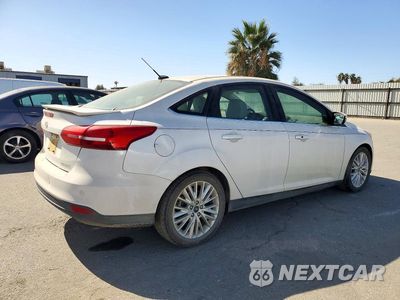 Trzecie zdjęcie samochodu z tyłu: 2017 FORD FOCUS TITANIUM VIN:1FADP3J22HL260740 - miniatura