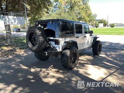 Czwarte zdjęcie samochodu z boku: 2015 JEEP WRANGLER UNLIMITED RUBICON VIN:1C4BJWFG3FL530855 - miniatura