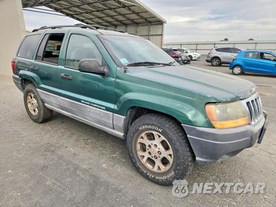 Czwarte zdjęcie samochodu z boku: 1999 JEEP GRAND CHEROKEE LAREDO VIN:1J4GW58S5XC687513 - miniatura