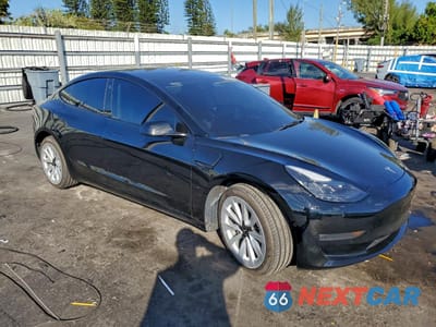 Czwarte zdjęcie samochodu z boku: 2022 TESLA MODEL 3 VIN:5YJ3E1EB6NF234263 - miniatura
